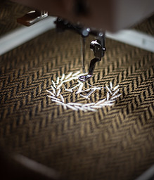 An embroidery machine stitching a logo onto fabric